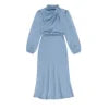 Model wearing the Kouvr Ellana blue satin long sleeve midi dress from the back