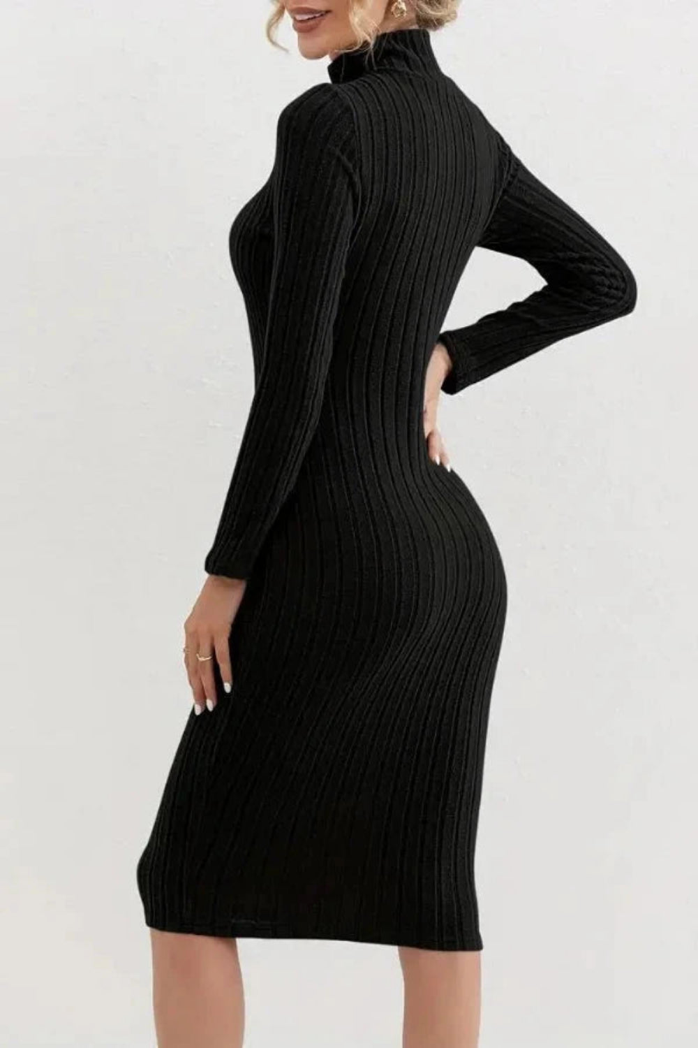 Model wearing the Kouvr Fashion long sleeve ribbed bodycon dress in black, holding a silver handbag