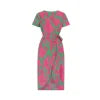 Model wearing Kouvr Fashion pink floral midi wrap dress walking on a cobblestone street
