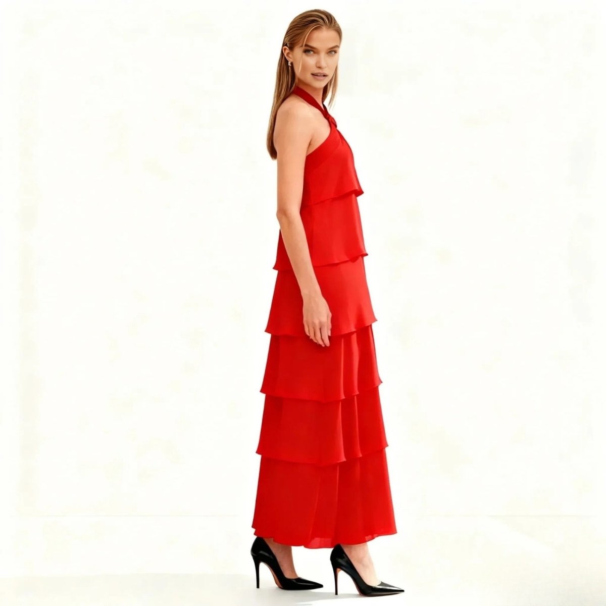 Woman wearing a red Kouvr tiered dress on a white background