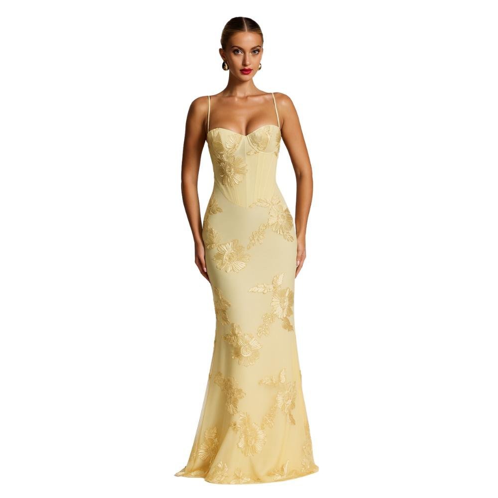 Woman wearing a yellow kouvr lace evening gown on a white background