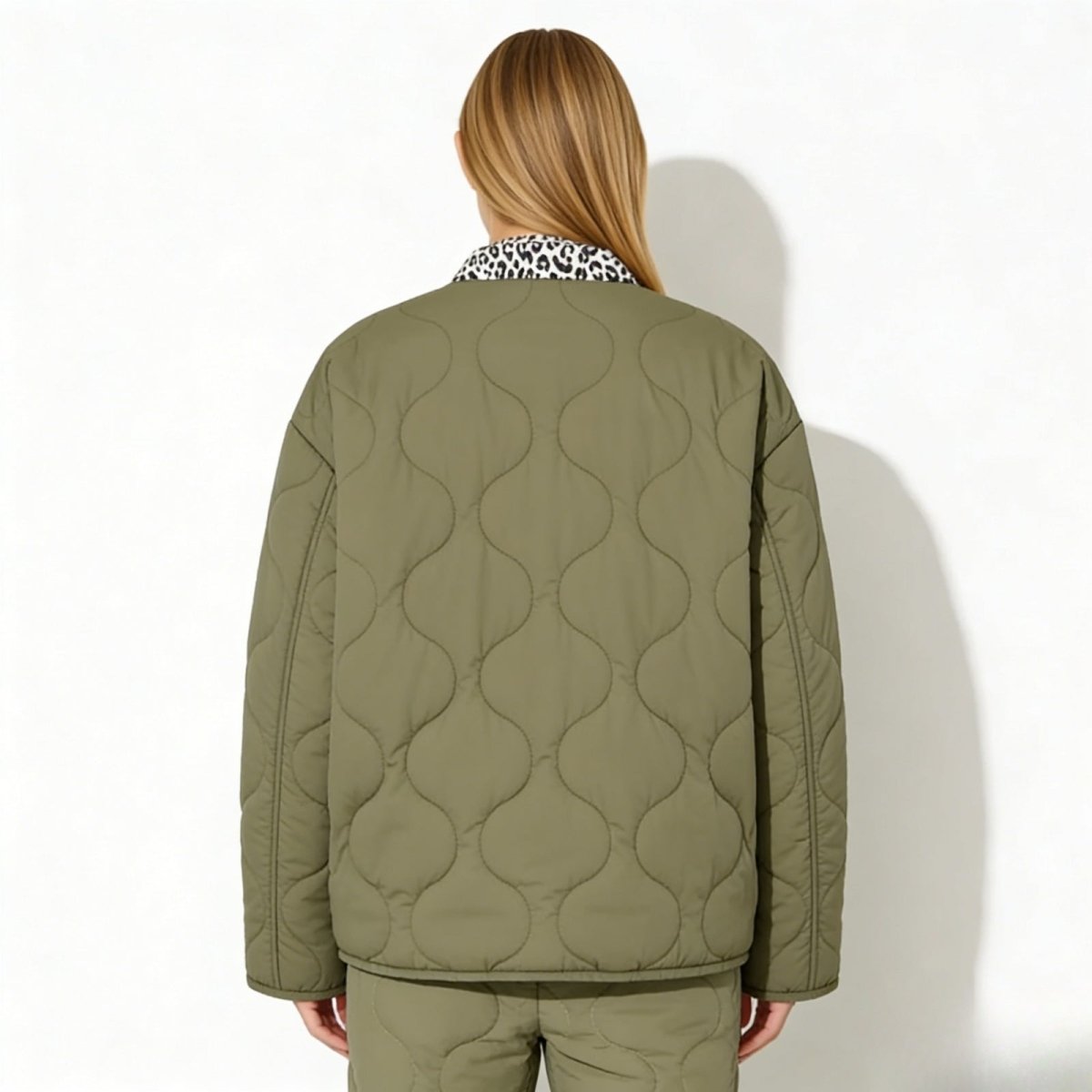 Back view of the Kouvr Fashion oversized quilted jacket in army green, highlighting the wavy onion quilting pattern.