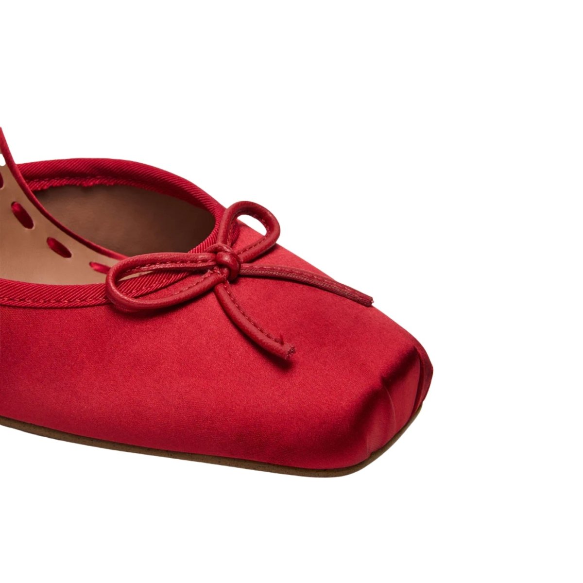 Red kouvr ballerina shoe with a bow on a white background
