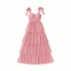 Pink Kouvr dress with ruffled layers on a plain background