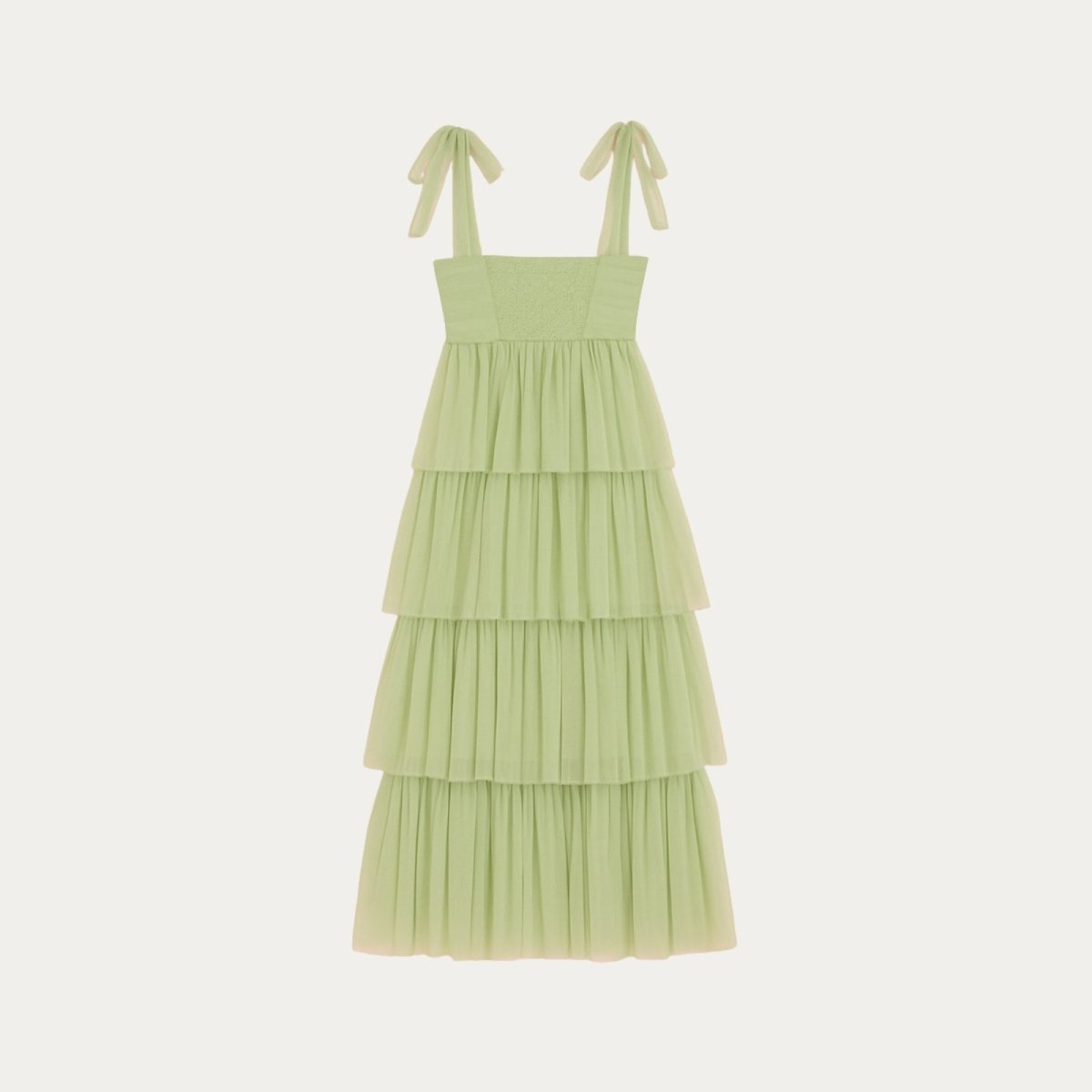Light green Kouvr tiered dress with ribbon straps on a white background