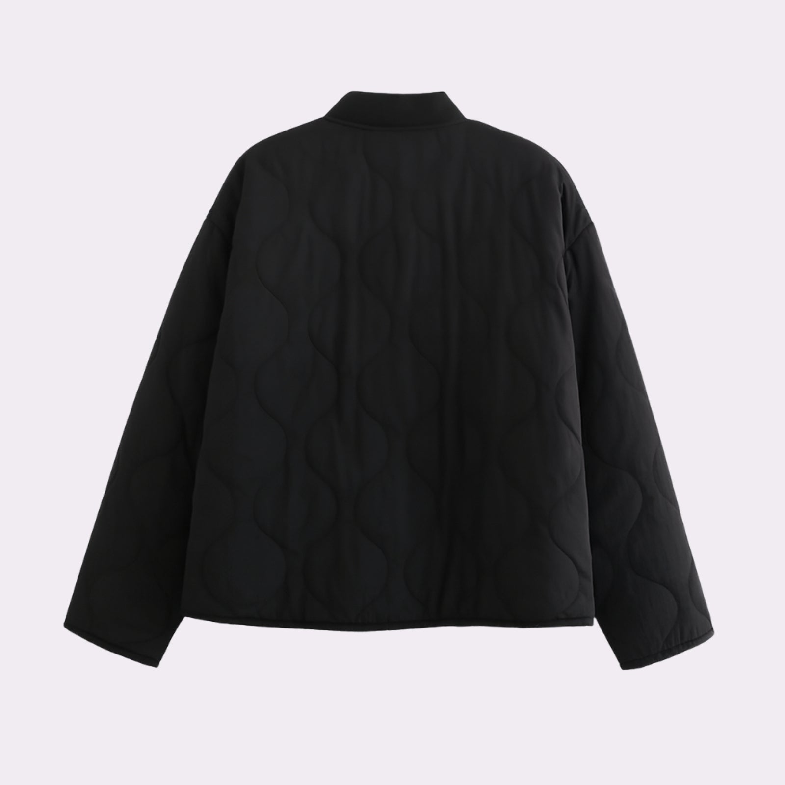 Product flat lay showing the back and signature wave quilting pattern of the Kouvr Fashion black lightweight puffer jacket.