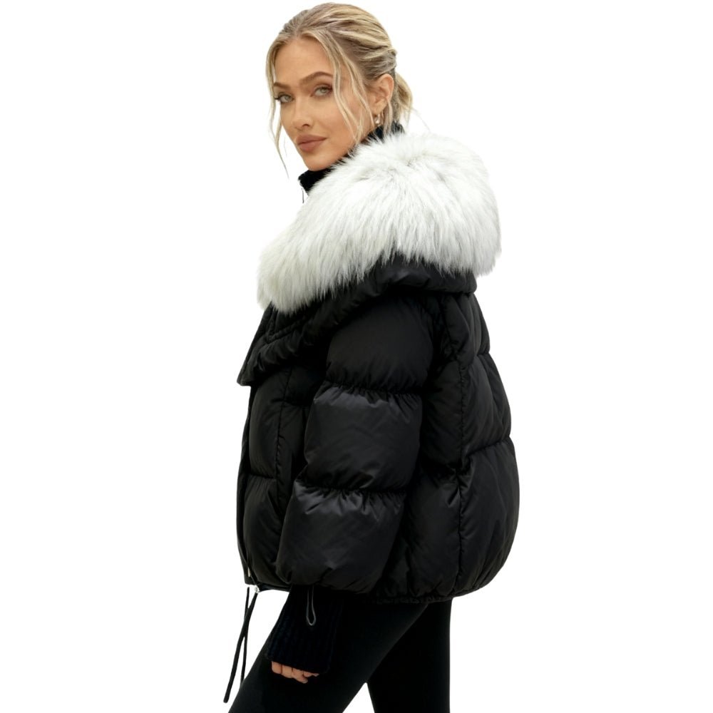 Black Kouvr puffer jacket with white fur collar worn by a model on a white background