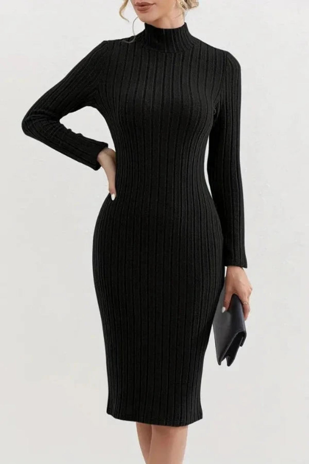 Model wearing the Kouvr Fashion long sleeve ribbed bodycon dress in black, holding a silver handbag