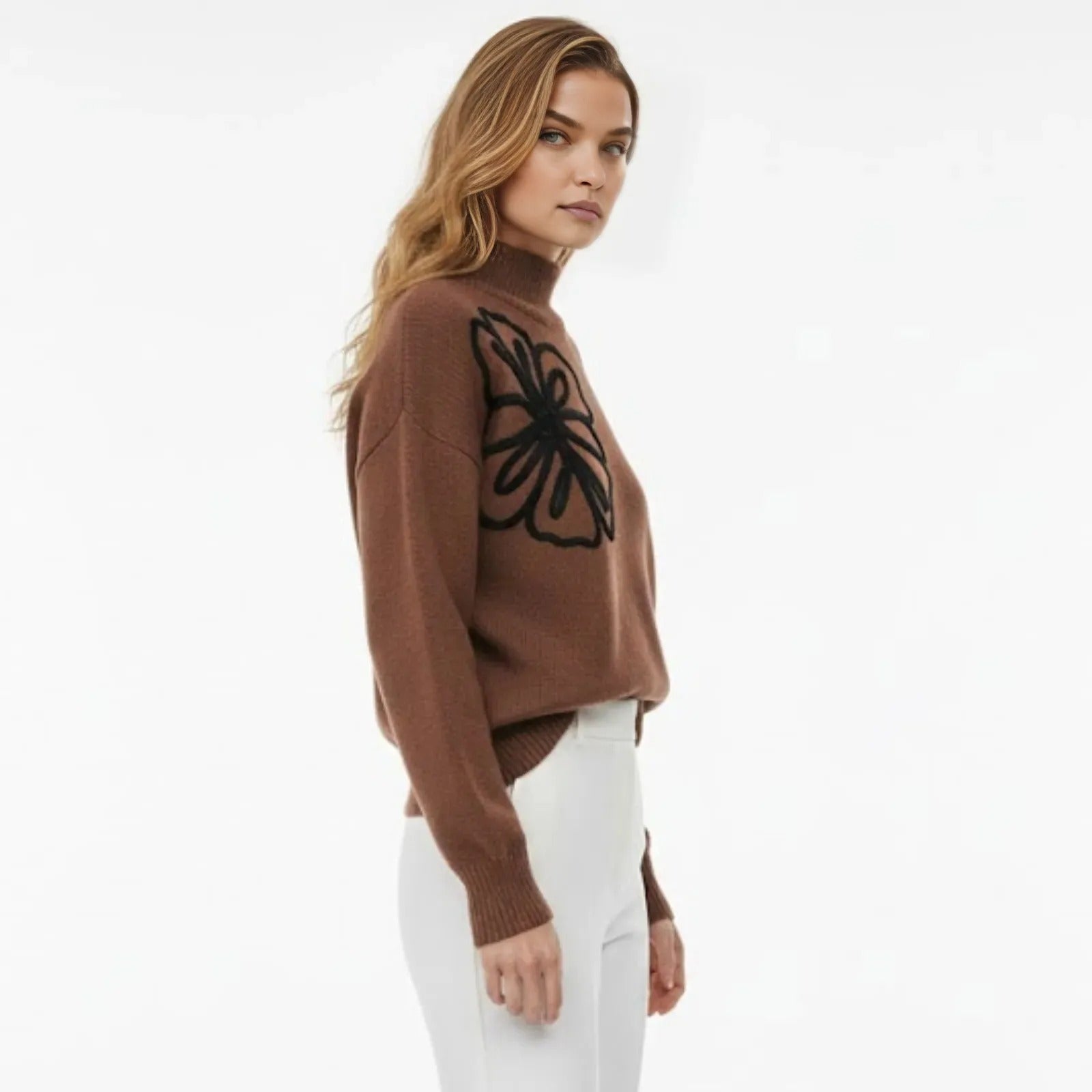 Model in a side profile view showcasing the oversized fit and sleeve embroidery of the Kouvr Fashion brown mock neck sweater.