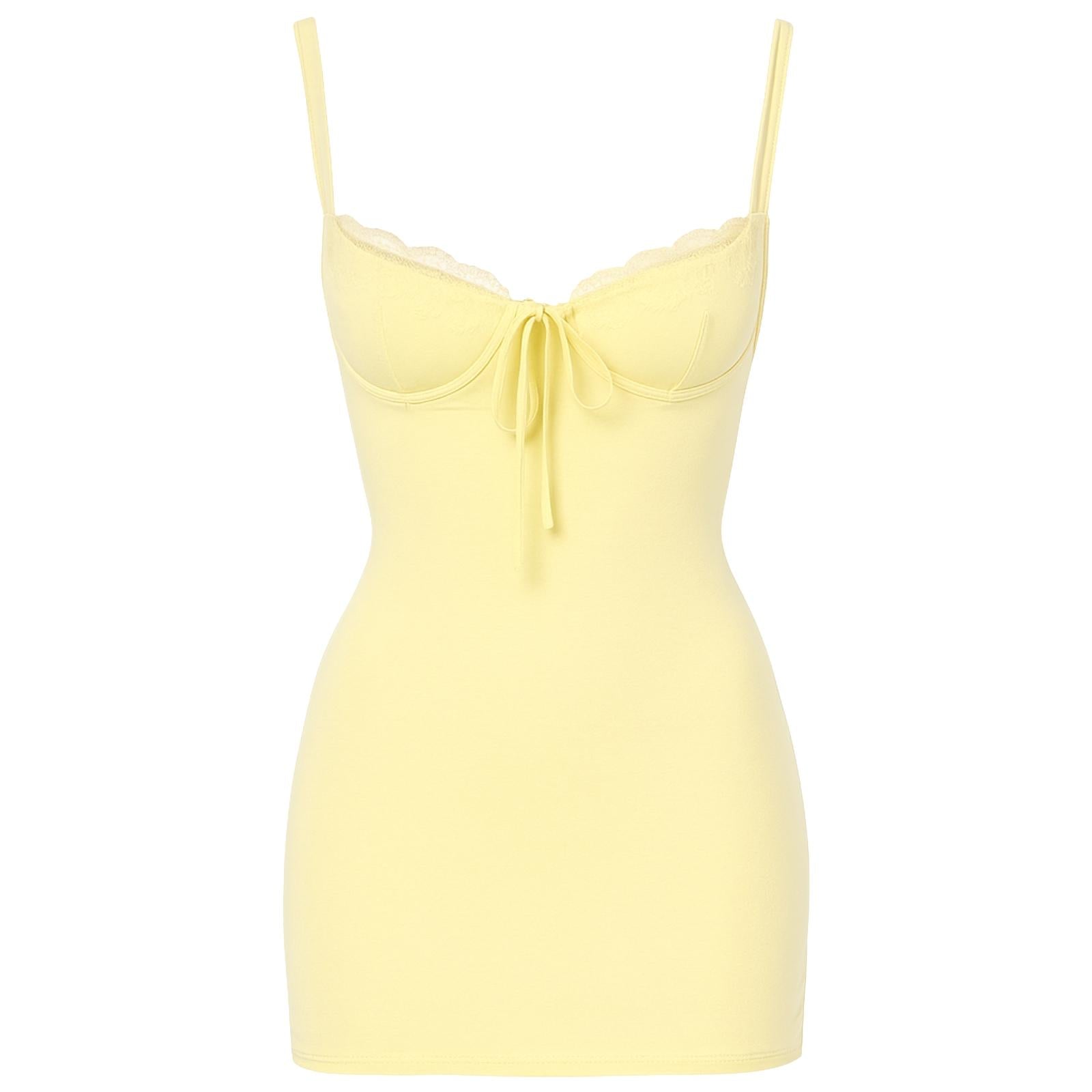 Woman wearing a light yellow kouvr slip dress on a white background