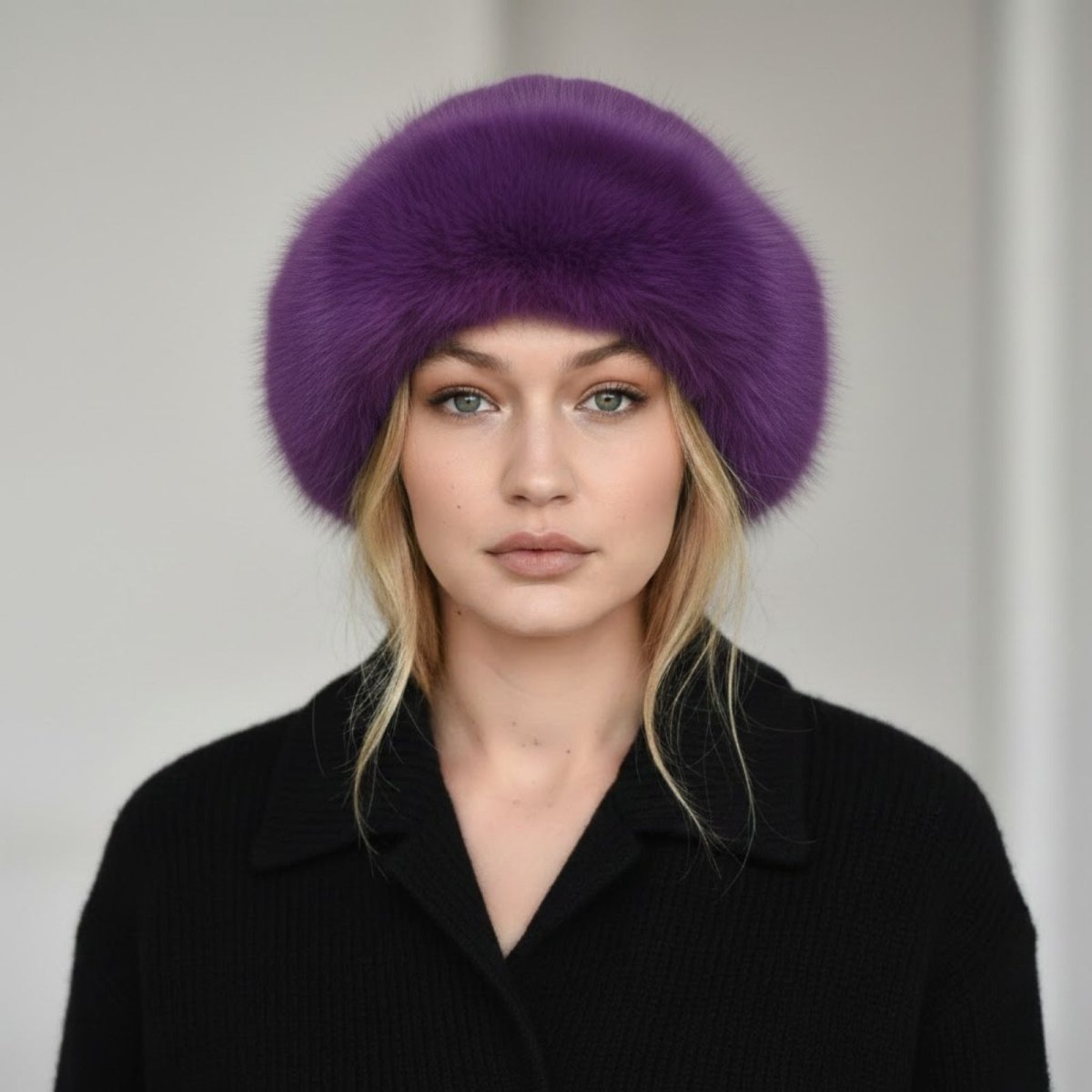 Woman wearing a purple fur hat against a plain background