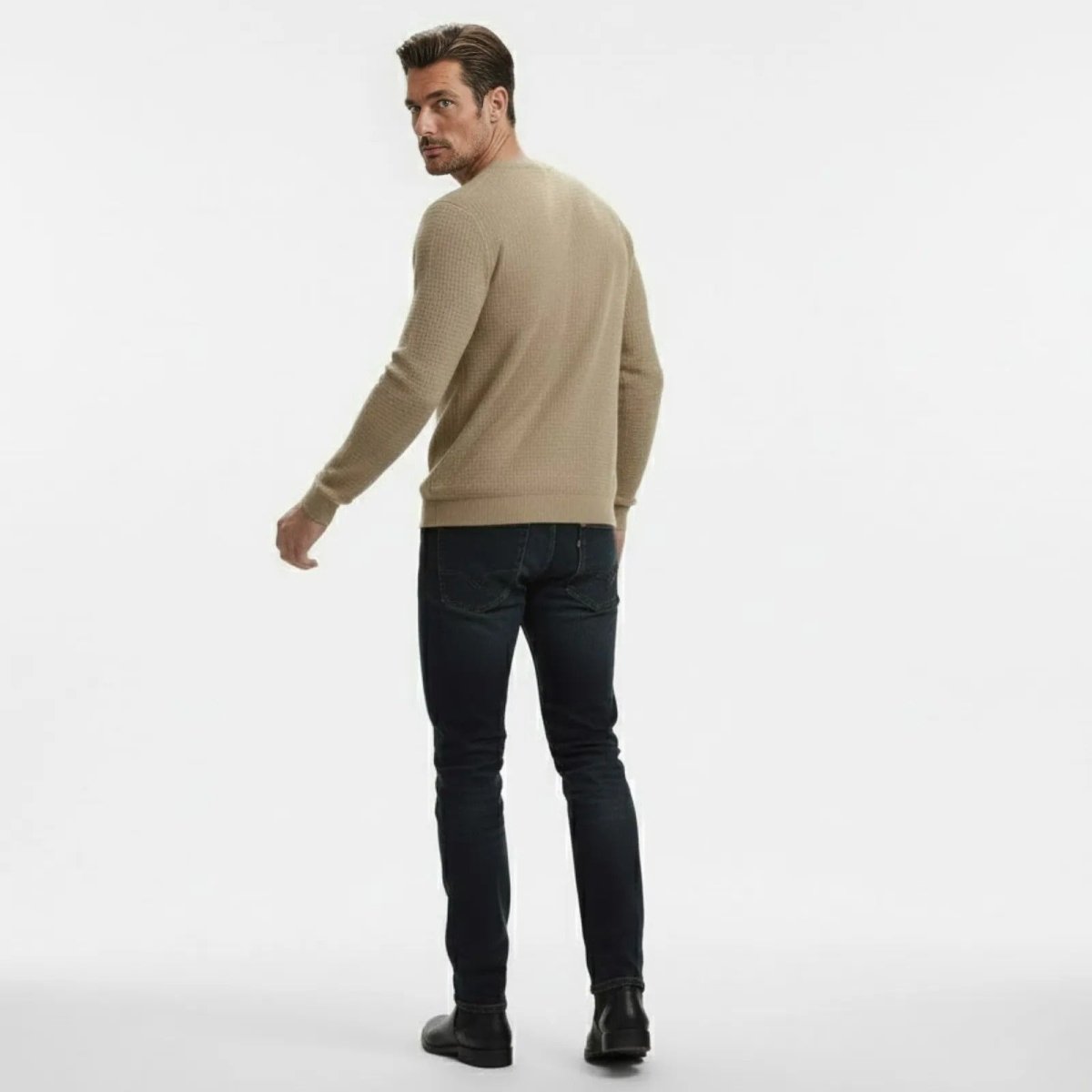 Rear view of a man in a Kouvr Fashion khaki textured sweater, highlighting the garment's fit and construction.
