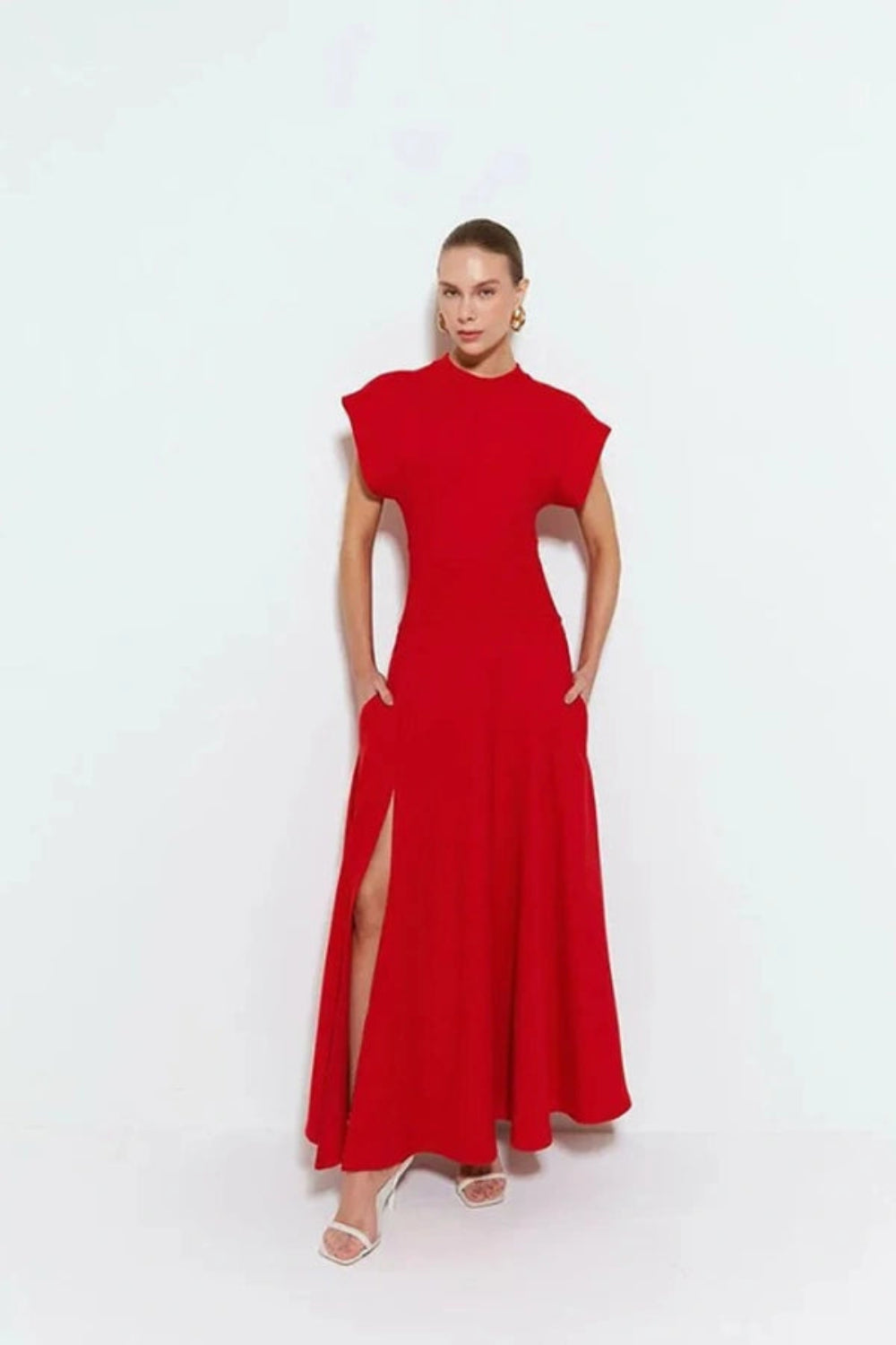 sculptural silhouette," "architectural design," "power dressing," "elegant," "crepe knit," and "wedding guest attire