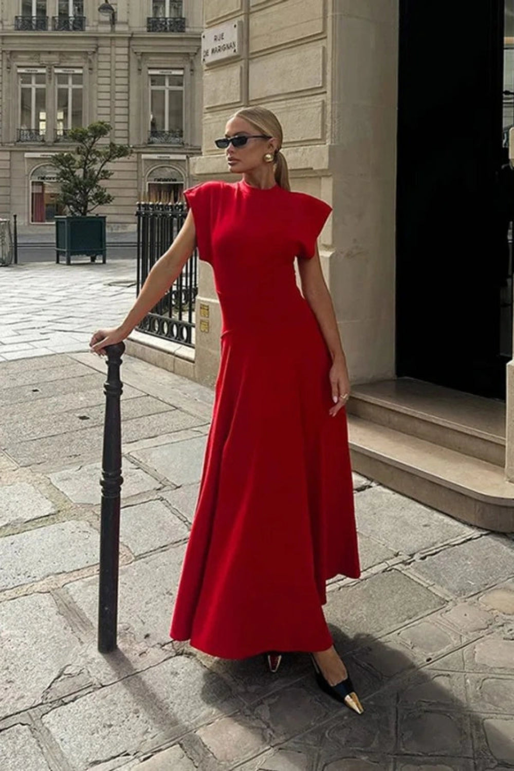 sculptural silhouette," "architectural design," "power dressing," "elegant," "crepe knit," and "wedding guest attire