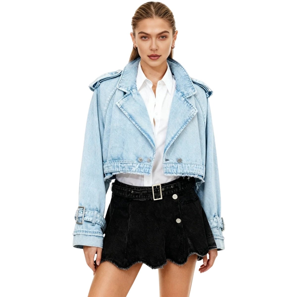 Model wearing Kouvr Fashion's washed light blue cropped denim moto jacket styled with a white collared shirt and matching denim skirt.