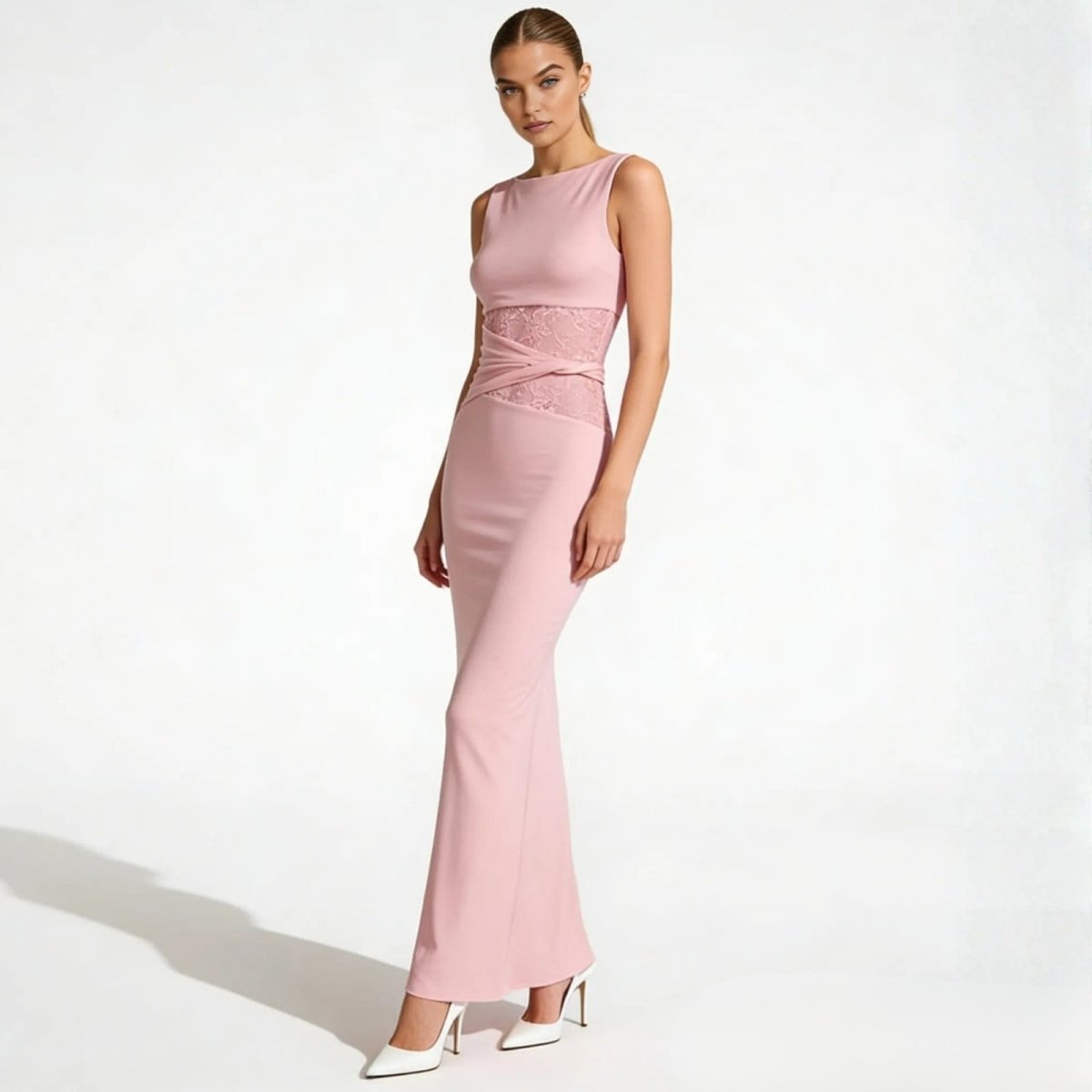 Angled view of a woman in the Kouvr Fashion deborah pink column gown, highlighting the figure-flattering silhouette and lace side panel.