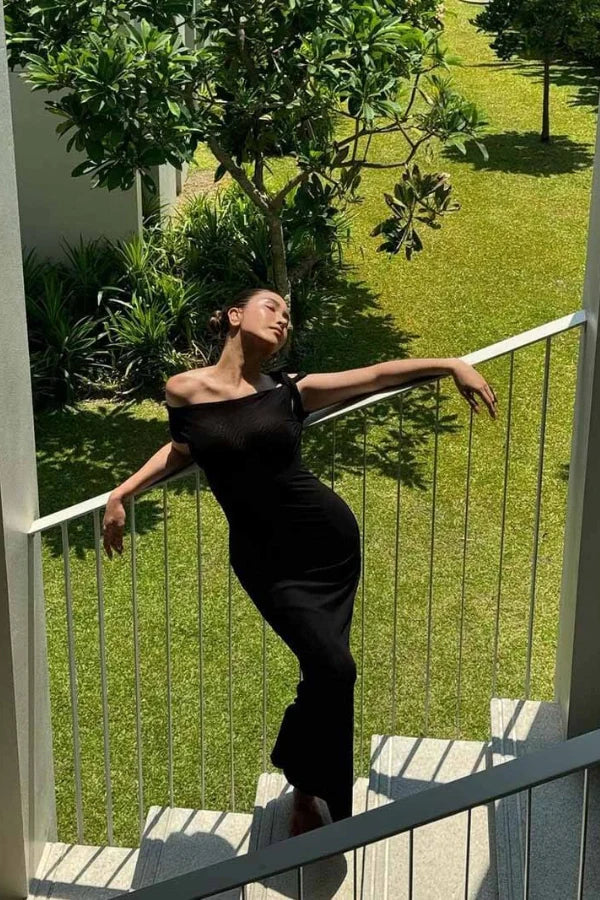 sculptural silhouette, draped jersey, architectural design, modern elegance, figure-flattering, minimalist formalwear, elevated essential.