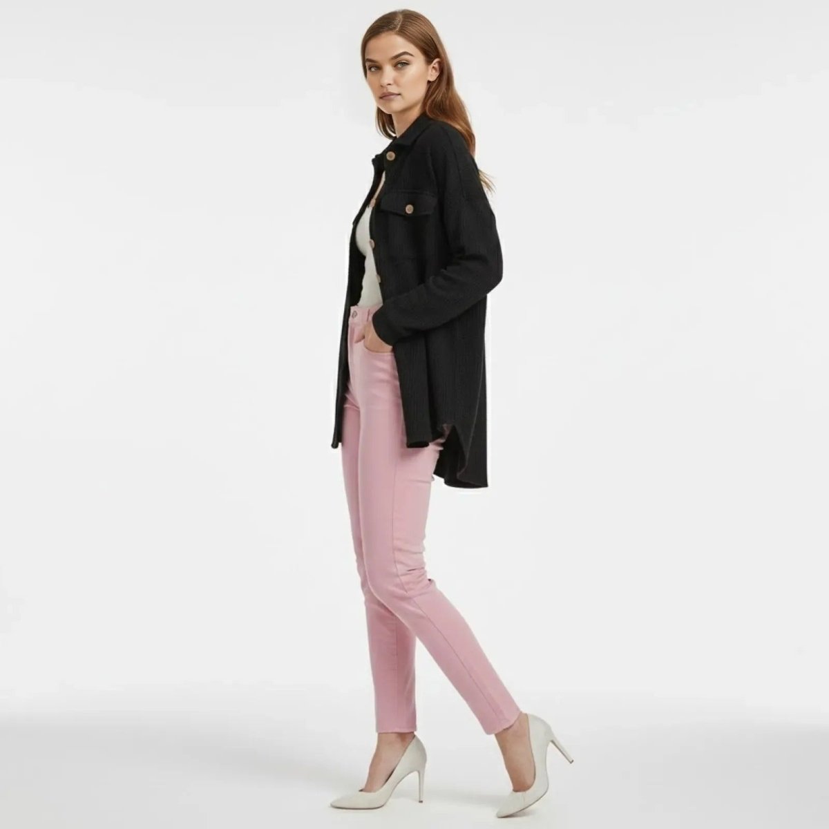 Side profile of a woman wearing the oversized black Donna Waffle Knit Shacket, showcasing its high-low hem and relaxed drape.