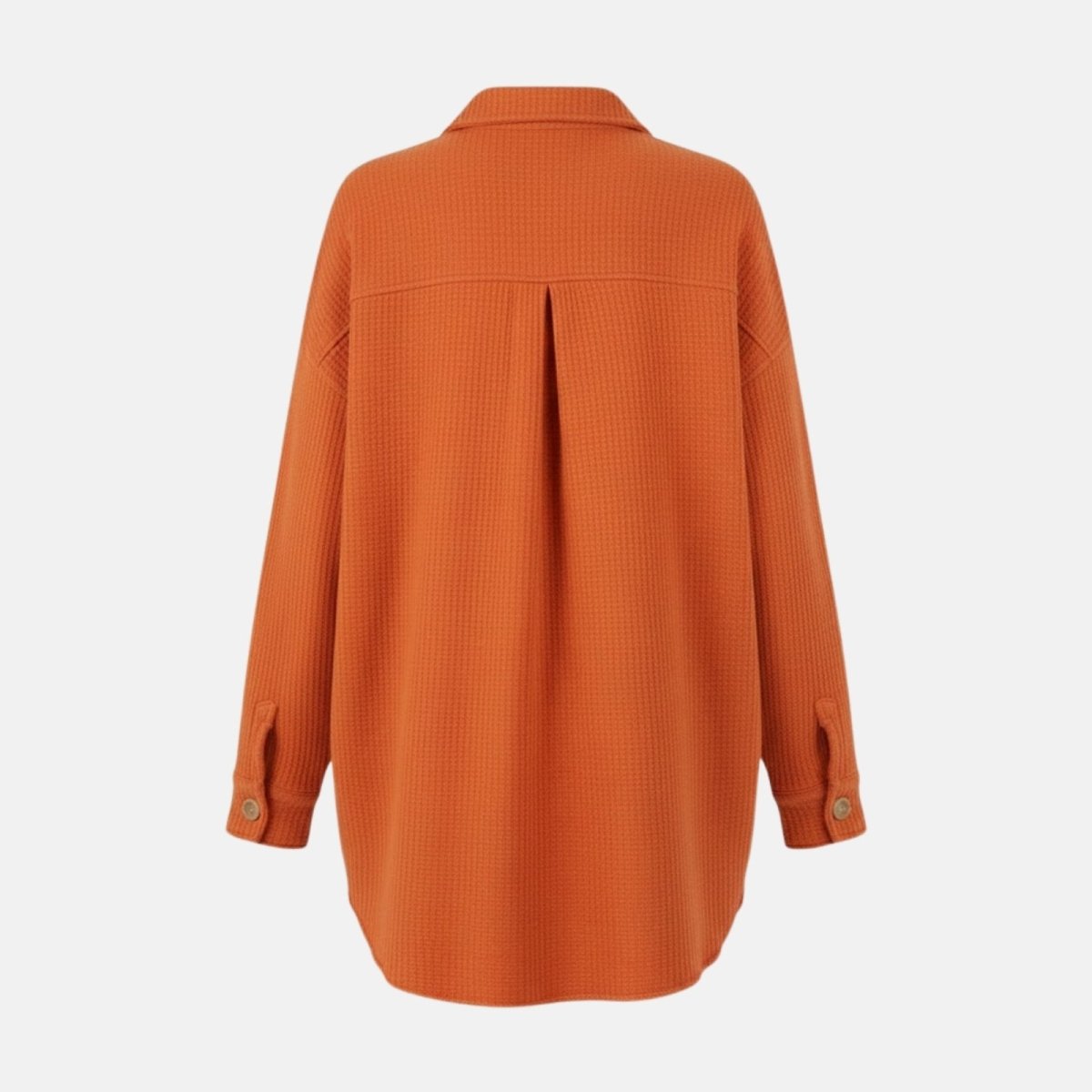 Flatlay of the back of the burnt orange waffle knit shacket detailing the back yoke, center pleat, and oversized construction.