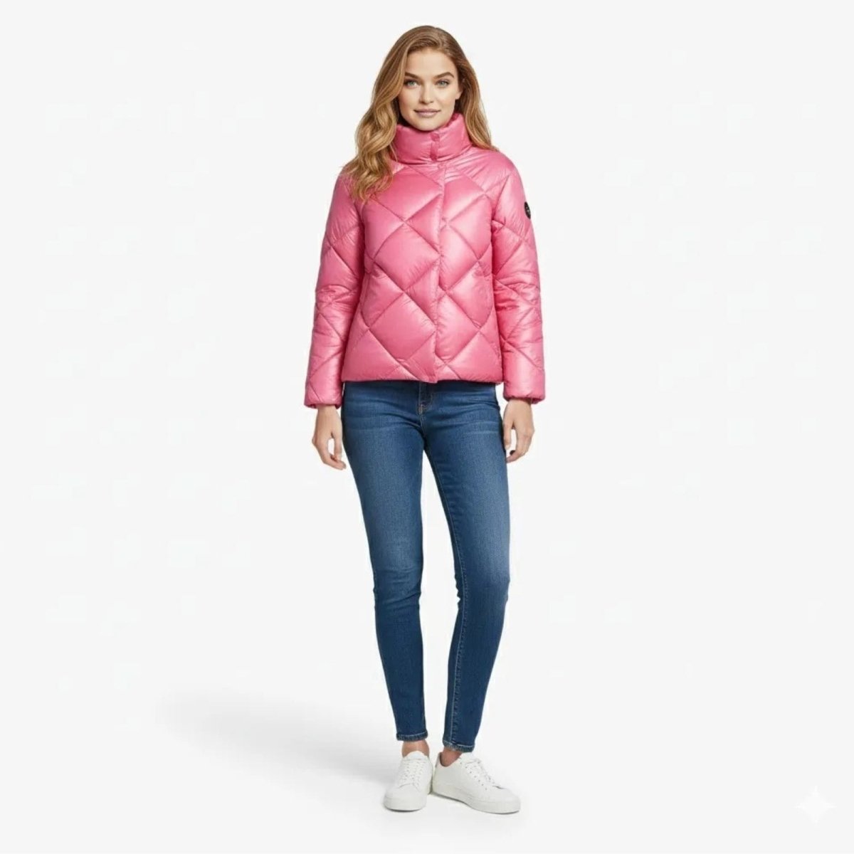 Model wearing the pink diamond quilted Elisse Puffer Jacket from Kouvr Fashion, shown from the front with a high funnel neck.