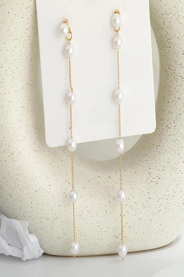 Pearl Kouvr earrings on a white background