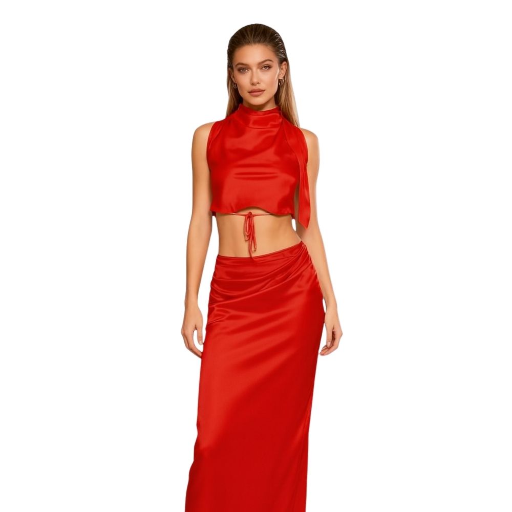 Woman wearing a red kouvr satin outfit on a white background