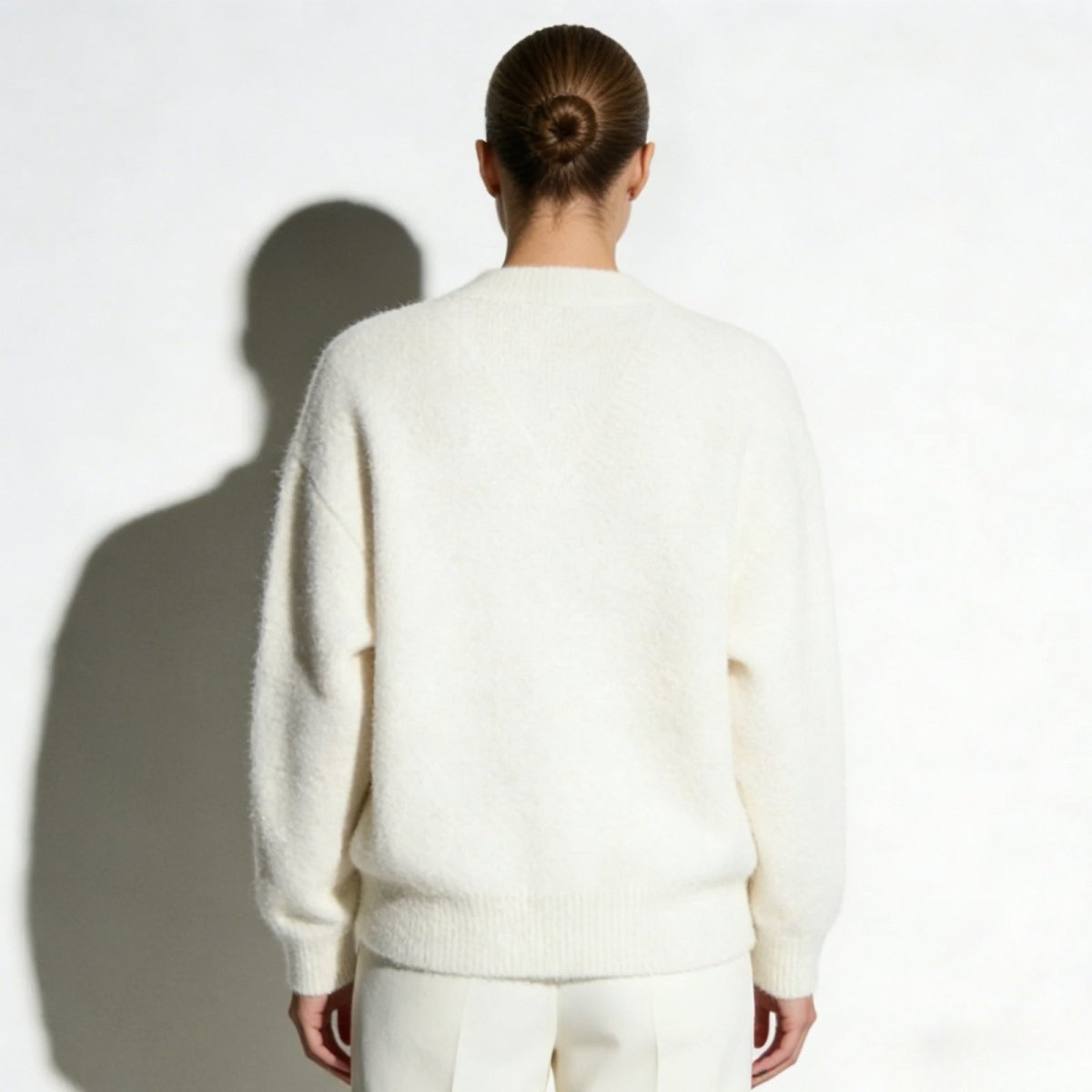 Back view of the Kouvr Fashion Gina Cardigan in white, highlighting the seamless knit and dropped shoulder details.
