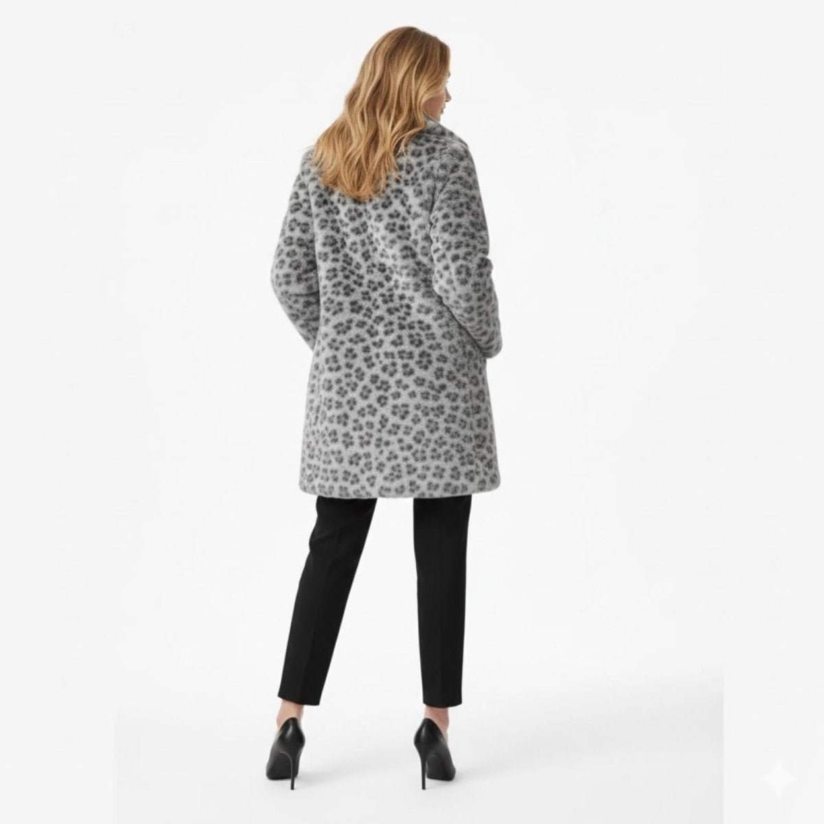 Back view of a model wearing the Kouvr Fashion mid-length coat, displaying the full snow leopard print pattern.