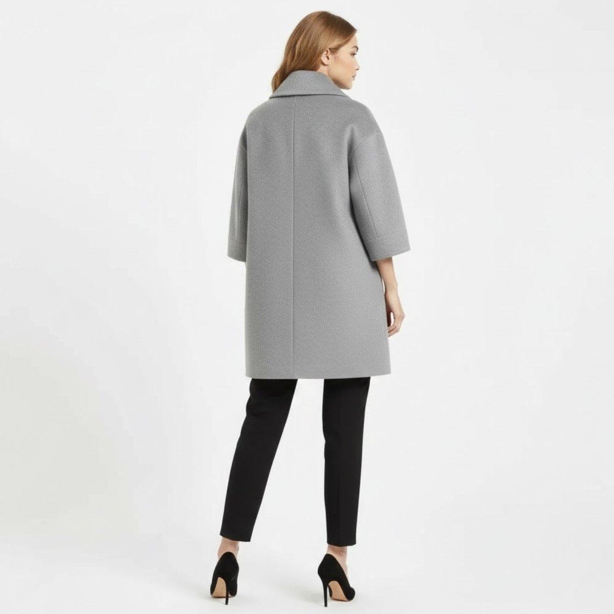Back view of the model wearing the Kouvr Fashion gray wool blend coat, showing the center seam and sleeve length.