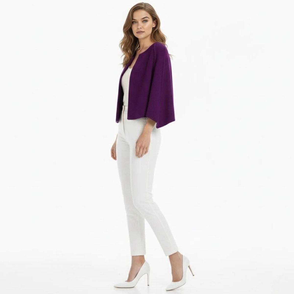 Side profile of a model in the Kouvr Fashion purple capelet, highlighting the elegant drape of the cape sleeves and its cropped silhouette.
