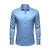 Front view of the Kouvr Fashion long-sleeve men's dress shirt in light blue with dark buttons, laid flat on a light grey background.