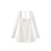 Model from behind wearing the Kouvr Fashion Louise white lace corset mini dress showing the adjustable back lacing