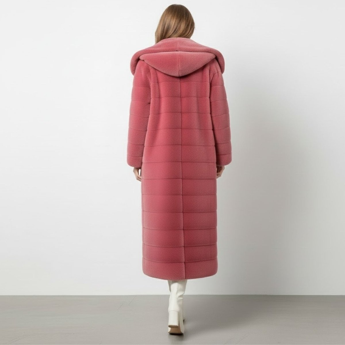 Back view of the pink hooded maxi coat, displaying the horizontal paneled design and the shape of the hood.