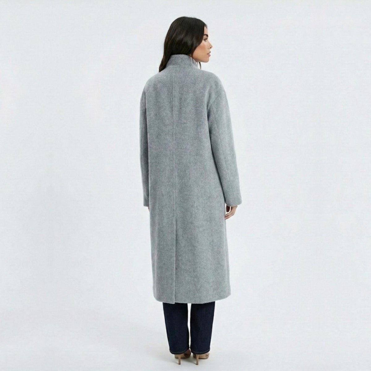 Back view of Madison Beer wearing the Maddie minimalist long grey wool coat from Kouvr Fashion, showing the clean lines and structure.