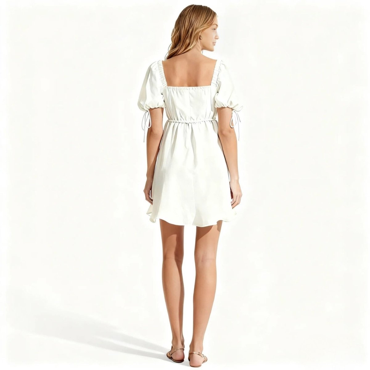 Woman wearing a white Kouvr dress on a white background