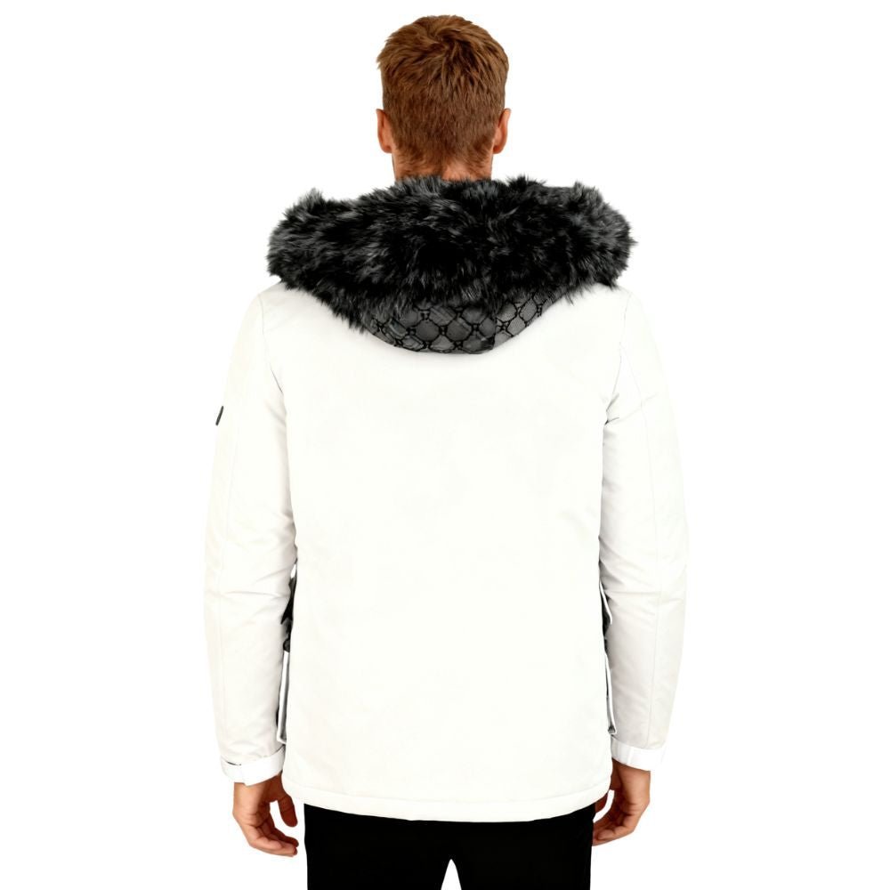 Person wearing a white kouvr jacket with a black fur hood on a white background