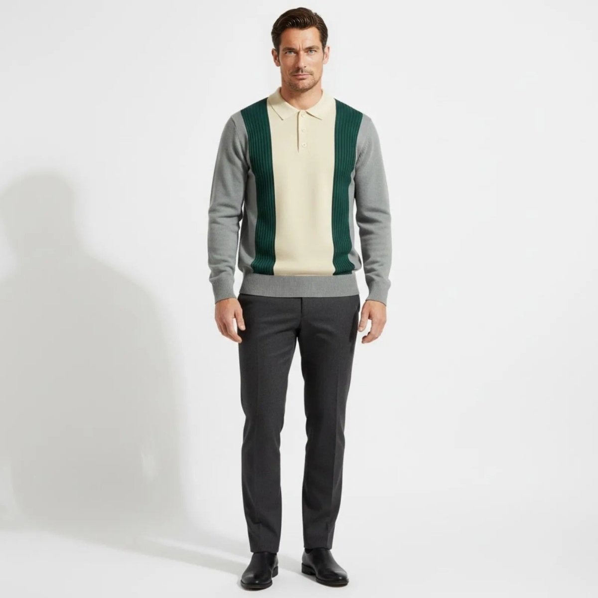 Model wearing the Kouvr Fashion leandro color block knit polo sweater in grey,  paired with dark grey tailored trousers.