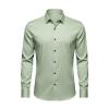Front product shot of the Kouvr Fashion long-sleeve dress shirt in light green, laid flat to display the full button placket and collar.