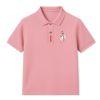 Man wearing the Kouvr slim fit Rose Quartz pink polo shirt with black trousers against a white background.