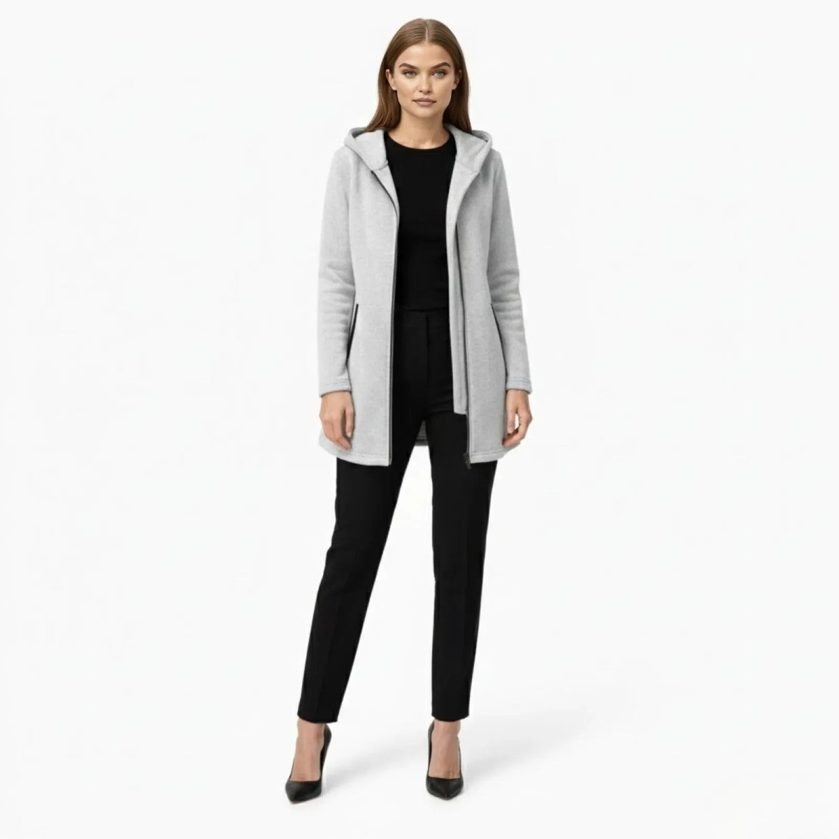 Model wearing the Kouvr Fashion light grey minimalist hooded coat, front view, styled with black trousers and heels.