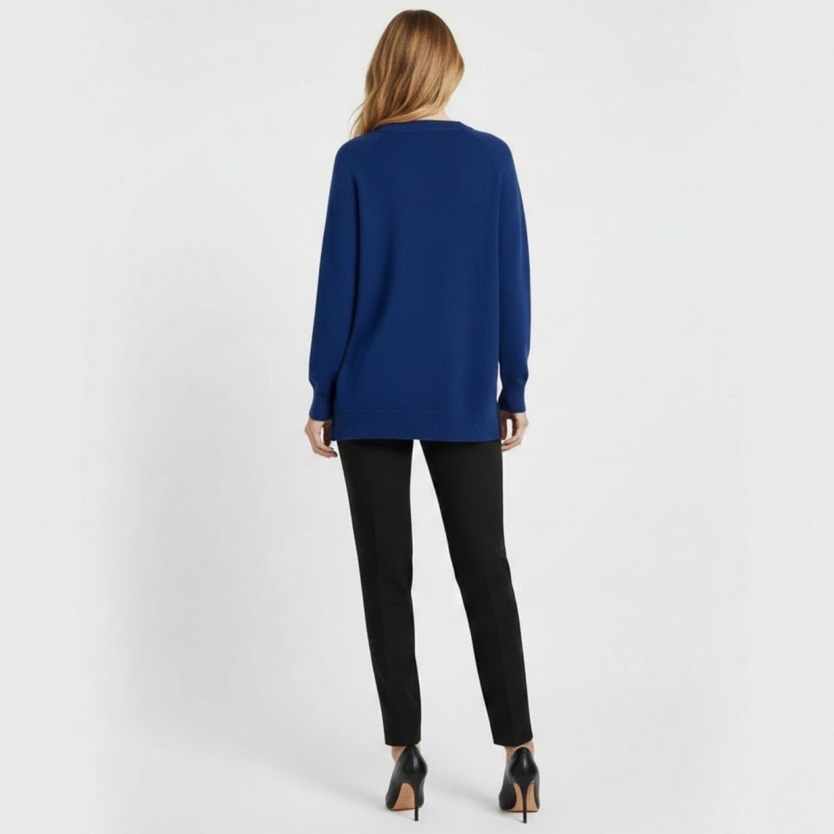 Back view of a model wearing the Kouvr Fashion oversized crewneck sweater in cobalt blue, showing the full length and silhouette.
