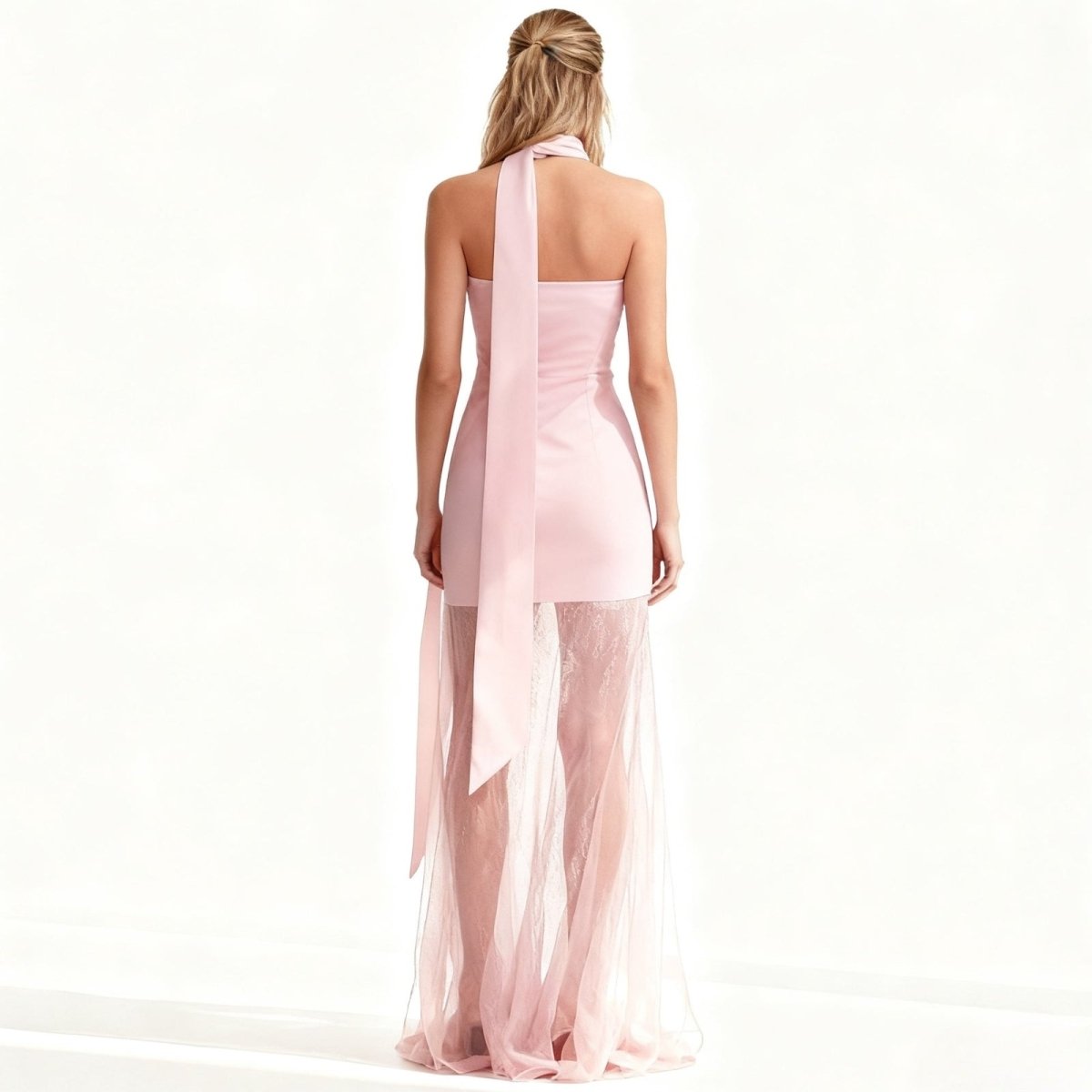 Woman wearing a pink Kouvr one-shoulder dress with a sheer overlay on a white background