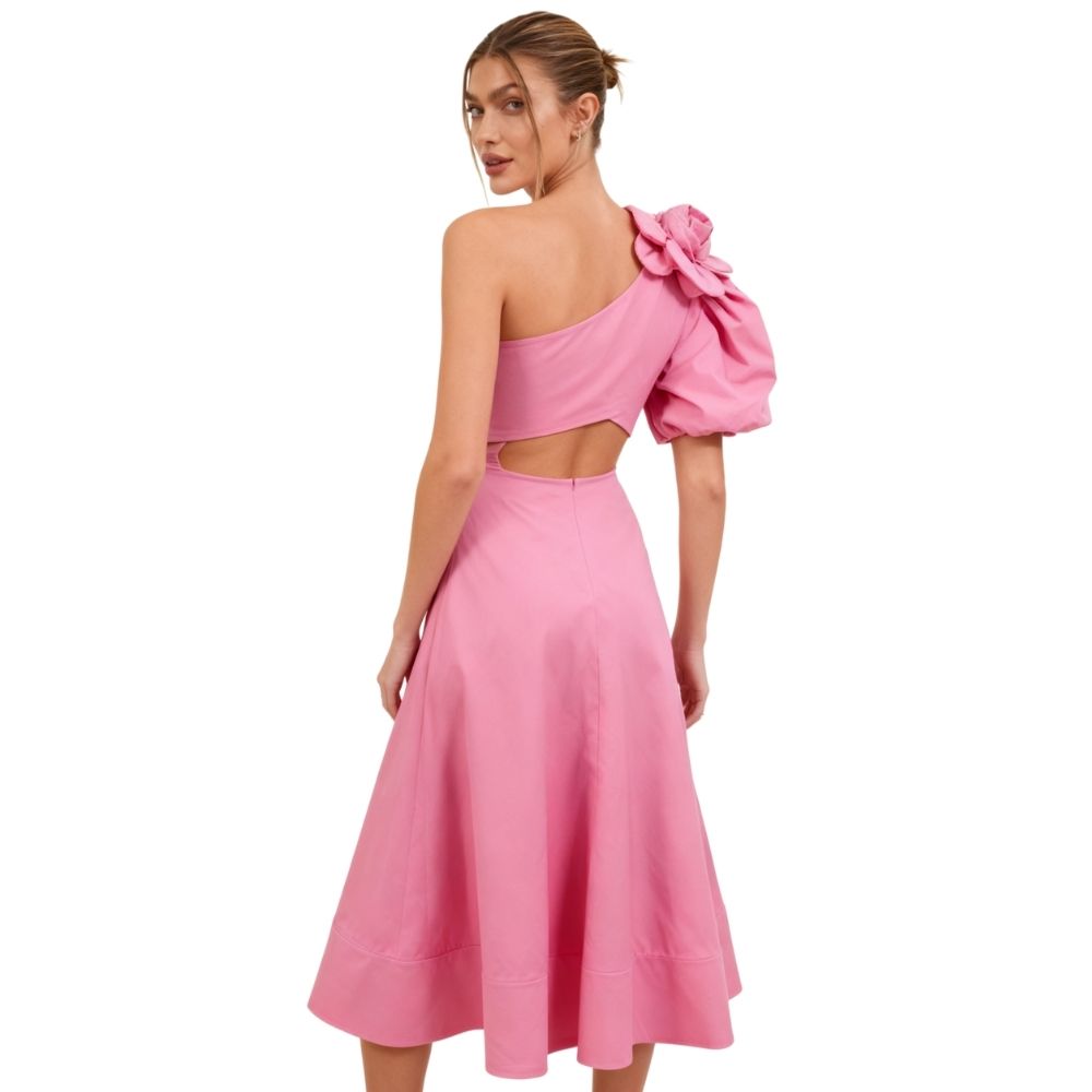 Model wearing Kouvr's pink one-shoulder midi dress with a large rose on the shoulder and a side waist cutout,