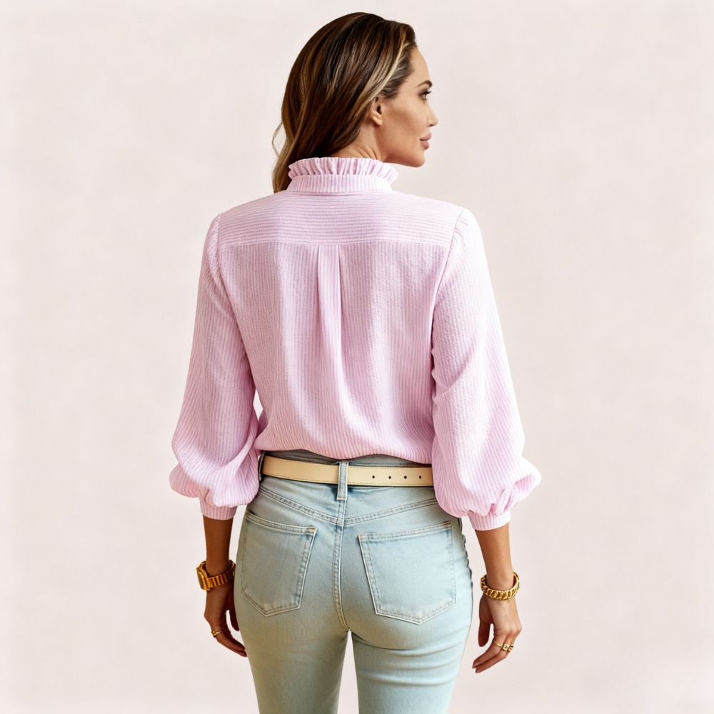 Model wearing the Kouvr women's white textured blouse with ruffle collar, paired with light wash jeans