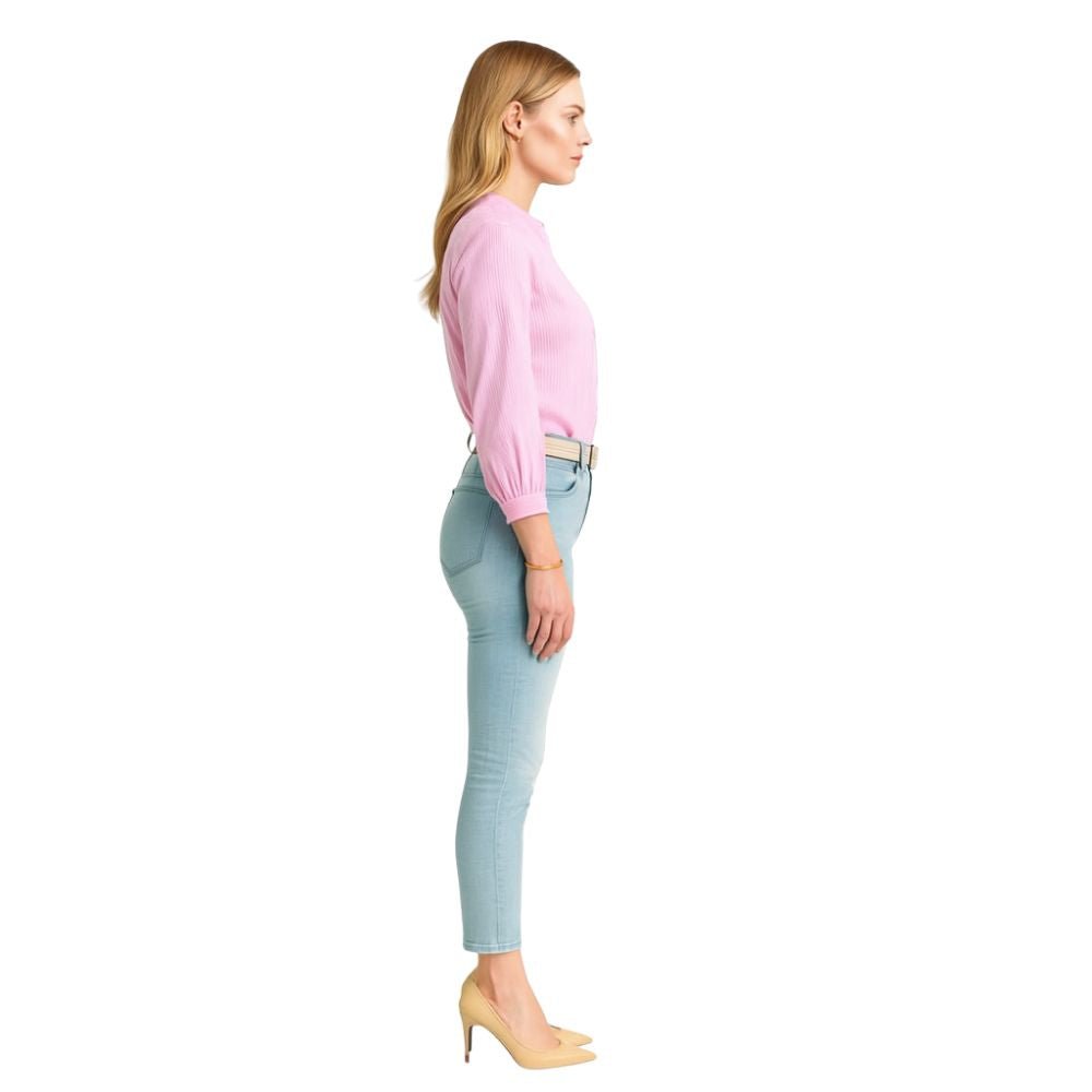 Model wearing the Kouvr women's white textured blouse with ruffle collar, paired with light wash jeans 