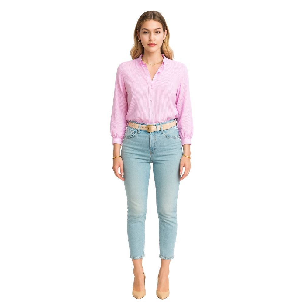 Model wearing the Kouvr women's white textured blouse with ruffle collar, paired with light wash jeans 