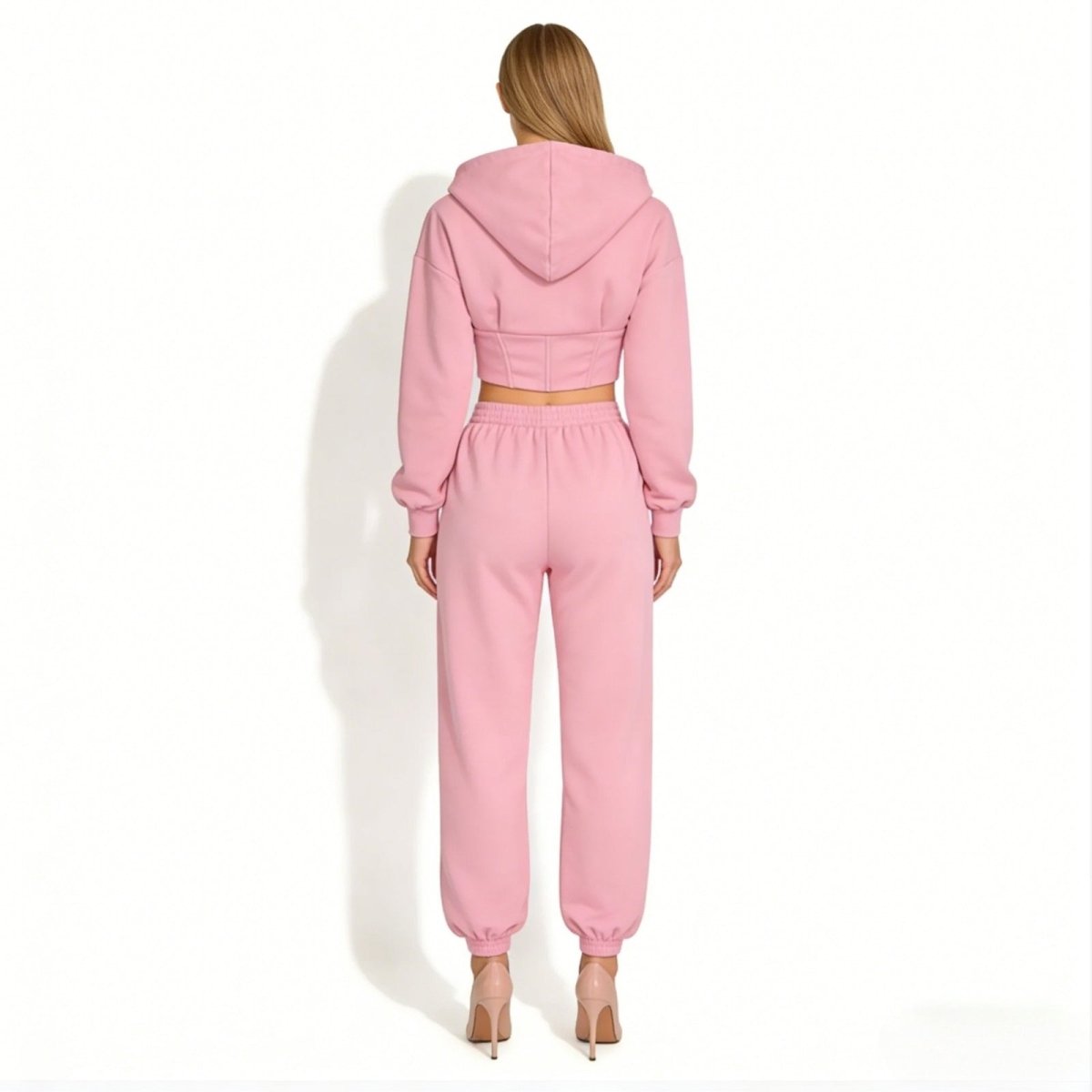 Back view of the Kouvr Fashion pink cropped hoodie showcasing the unique corset boning detail for a snatched waist.
