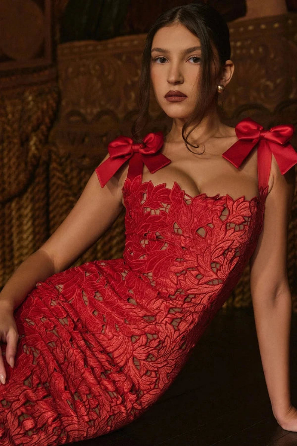 Back view of the Kouvr Fashion Penelope lace gown showing the rear slit and bow strap detail