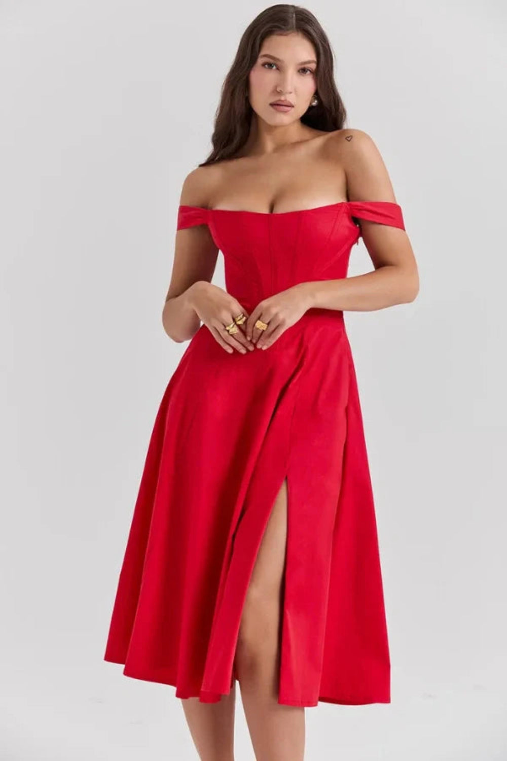 Bardot neckline, bustier dress, A-line skirt, thigh-high slit, lace-up back, wedding guest attire, structured bodice, statement dress