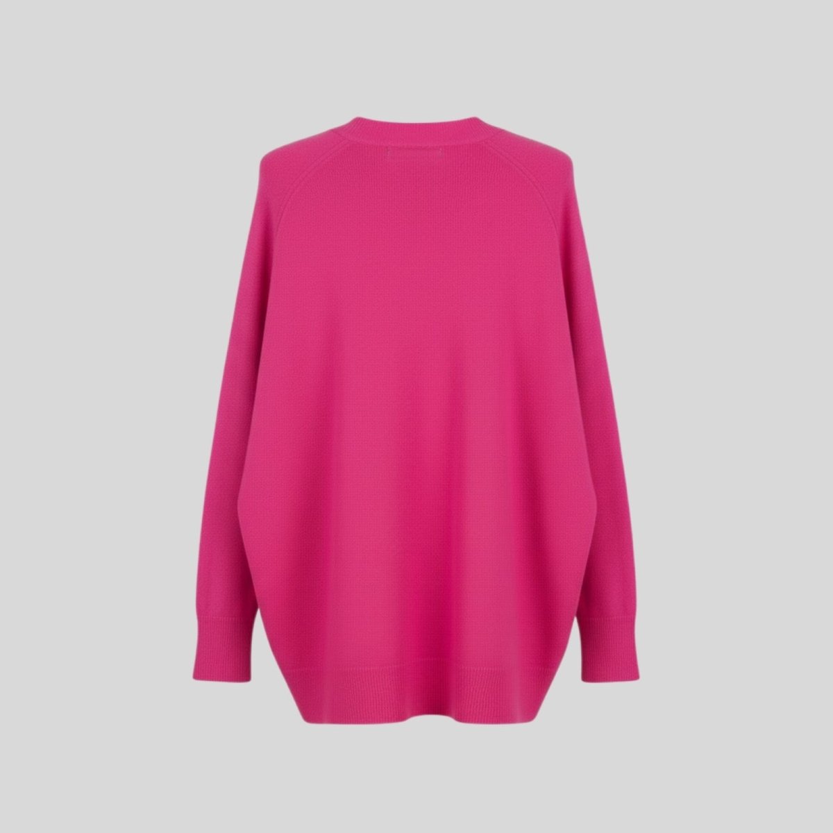 Back product shot of the Kouvr Fashion fuschia pink oversized cashmere wool blend sweater, detailing the textured knit.